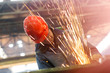 © Rafal Rodzoch/Caia Image - Welder using welding torch with sparks in steel factory