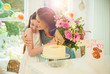 © Robert Daly/Caia Image - Affectionate daughter giving flower bouquet to mother on Mother‚Äôs Day