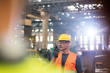 © Lukasz Olek/Caia Image - Steel worker using walkie-talkie in factory