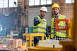 © Lukasz Olek/Caia Image - Steel workers talking and pointing in factory