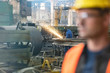 © Lukasz Olek/Caia Image - Welder using welding torch in steel factory