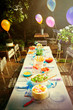 © Robert Daly/Caia Image - Balloons and food at garden party patio table