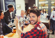 © Paul Bradbury/Caia Image - Portrait smiling, confident male bartender serving beer at bar