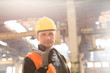 © Rafal Rodzoch/Caia Image - Portrait confident steel worker holding large wrench in factory