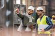 © Agnieszka Olek/Caia Image - Manager and steel worker talking and looking away in factory