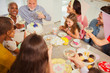 © Robert Daly/Caia Image - Multi-ethnic multi-generation family toasting with champagne at table