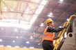 © Lukasz Olek/Caia Image - Steel worker climbing ladder in factory