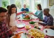 © Robert Daly/Caia Image - Multi-generation family eating at Christmas dinner table