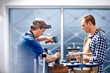 © Trevor Adeline/Caia Image - Jewelers using equipment in workshop