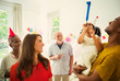 © Robert Daly/Caia Image - Multi-ethnic family celebrating with party favors
