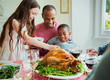 © Robert Daly/Caia Image - Multi-ethnic family enjoying Christmas turkey dinner at table