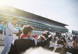 © Sam Edwards/Caia Image - Formula one racing team driver spraying champagne, celebrating victory on sports track