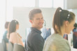 © Tom Merton/Caia Image - Portrait smiling male telemarketer wearing headset at computer in sunny office