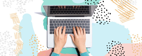 Person using a laptop computer on memphis background
