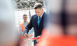 © Agnieszka Olek/Caia Image - Businessman cutting ribbon at new construction site ceremony