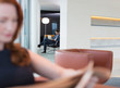 © Martin Barraud/Caia Image - Business people using laptop and reading newspaper in lounge