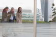 © Martin Barraud/Caia Image - Business people walking on urban highrise balcony