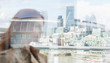 © Martin Barraud/Caia Image - Businesswoman on urban balcony with city view, London, UK