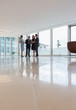 © Martin Barraud/Caia Image - Business people talking in modern office lounge