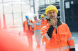 © Rafal Rodzoch/Caia Image - Male foreman using walkie-talkie at construction site