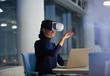 © Sam Edwards/Caia Image - Businesswoman using virtual reality simulator at laptop in office