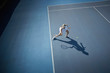 © Chris Ryan/Caia Image - Overhead view young female tennis player playing tennis, hitting the ball on sunny blue tennis court