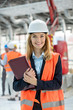 © Rafal Rodzoch/Caia Image - Portrait smiling female engineer at construction site