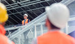 © Agnieszka Olek/Caia Image - Businessman in hard-hat looking over construction site