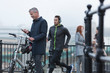 © Martin Barraud/Caia Image - Businessman bicycle texting cell phone male runner on urban ramp