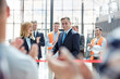 © Agnieszka Olek/Caia Image - Smiling businessman businesswoman cutting ribbon at new construction site ceremony