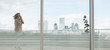 © Martin Barraud/Caia Image - Businesswoman talking on cell phone on urban balcony with city view