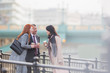 © Martin Barraud/Caia Image - Business people drinking coffee and talking on urban ramp