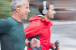 © Martin Barraud/Caia Image - Smiling male runners with headphones running