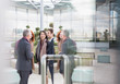 © Martin Barraud/Caia Image - Business people talking in office lobby