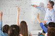 © Martin Barraud/Caia Image - Male teacher leading physics lesson at whiteboard in classroom