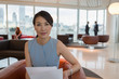 © Martin Barraud/Caia Image - Portrait confident businesswoman reviewing paperwork in office lounge