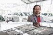 © Martin Barraud/Caia Image - Portrait smiling, confident car salesman in car dealership showroom