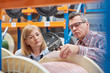 © Lukasz Olek/Caia Image - Male female supervisors using IR code scanner, scanning spool in fiber optic warehouse