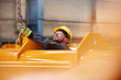 © Lukasz Olek/Caia Image - Male worker attaching chain to equipment in factory