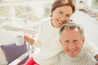 © Sam Edwards/Caia Image - Portrait smiling mature couple hugging and drinking coffee