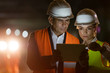 © Agnieszka Olek/Caia Image - Construction worker engineer using digital tablet at dark construction site