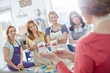 © Agnieszka Olek/Caia Image - Female artists listening to instructor explaining class in art painting class workshop