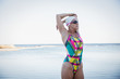 © Caiaimage/Sam Edwards/Caia Image - Female open water swimmer stretching arm at ocean
