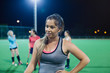 © Sam Edwards/Caia Image - Tired young female field hockey player resting on field at night