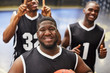 © Chris Ryan/Caia Image - Portrait smiling, confident young male basketball player team in black jerseys gesturing, celebrating victory