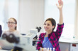 © Robert Daly/Caia Image - Smiling girl student asking a question behind microscope in classroom laboratory