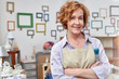 © Rafal Rodzoch/Caia Image - Portrait smiling mature female artist in art shop with picture frames