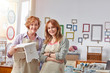© Rafal Rodzoch/Caia Image - Portrait smiling, confident female artists holding painted bench in art class workshop