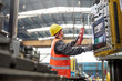 © Agnieszka Olek/Caia Image - Male worker operating machinery at control panel in factory