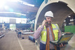 © Agnieszka Olek/Caia Image - Male engineer with laptop talking on cell phone in steel factory